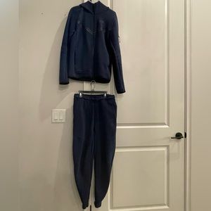 Navy Blue Nike Tech. Jacket Size: Men’s Extra Small. Pants Size: Men’s Small